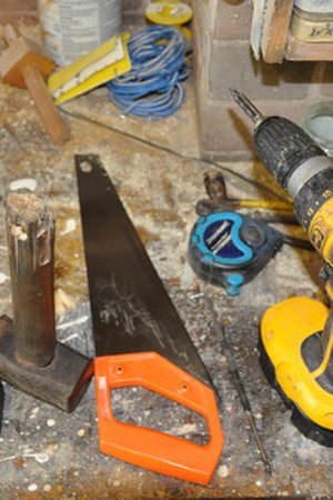 Handyman plumbing work under a kitchen sink